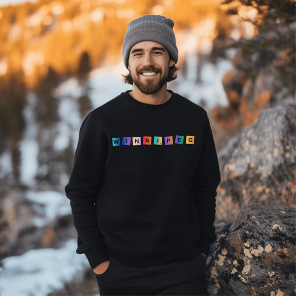 Introducing our newest addition to your wardrobe - the trendy graphic sweatshirt featuring colorful Winnipeg Scrabble Titles.